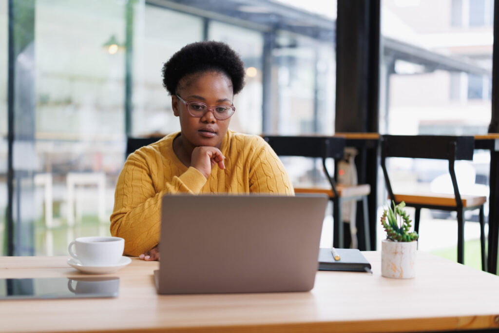 A Georgia small business owner at a laptop reviewing registration documents, focused on avoiding filing errors.