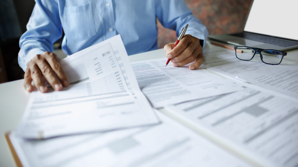 Small business owner reviewing financial records while preparing for IRS small business enforcement changes in 2026