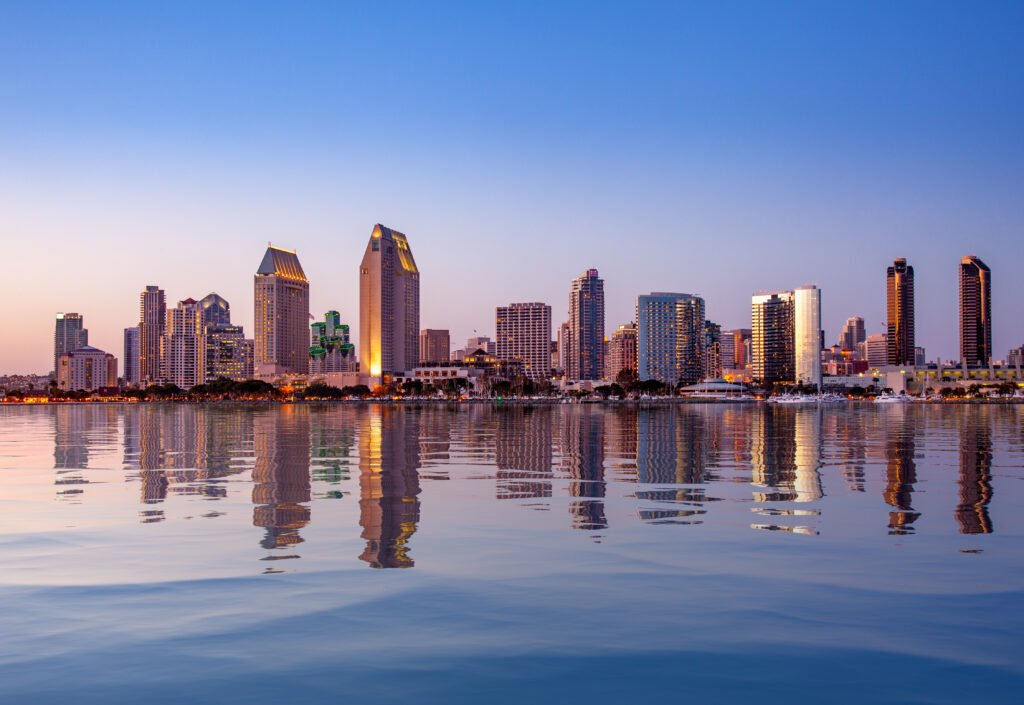San Diego small business owner reviewing compliance documents at a desk