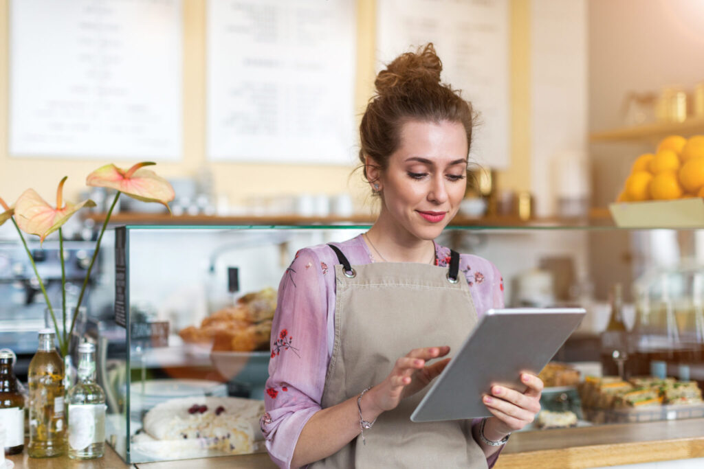 Young woman using digital tablet in coffee shop
